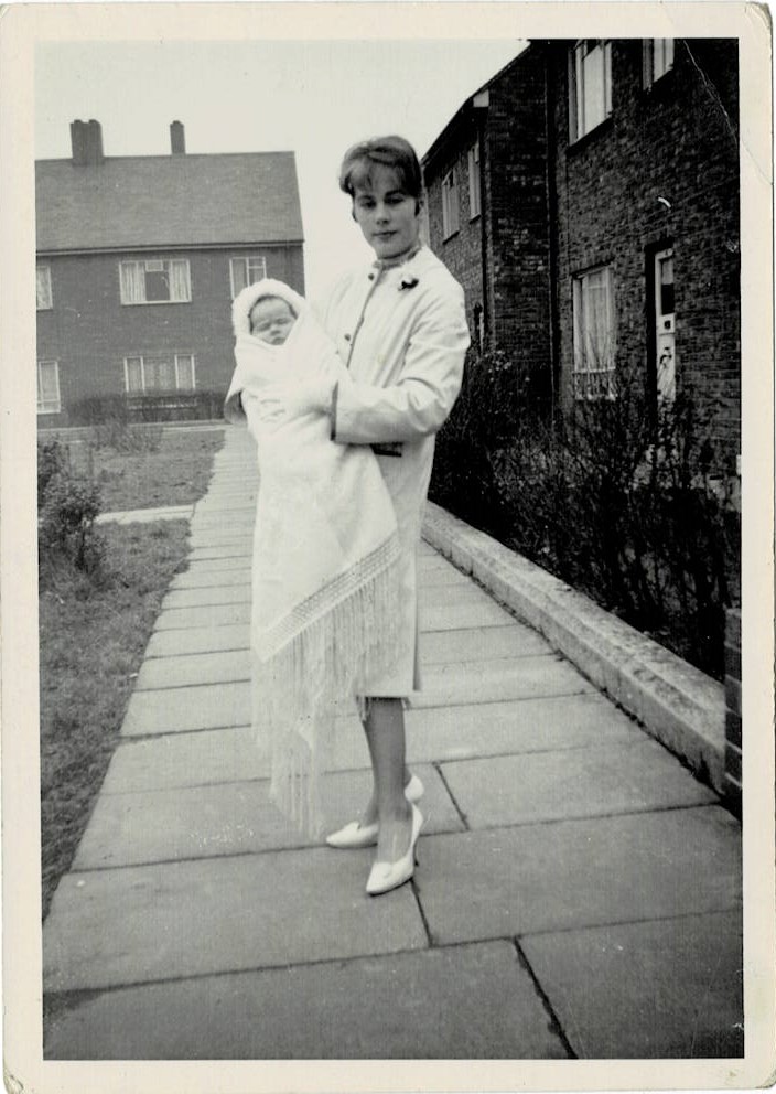 Outside my first home, with my mother